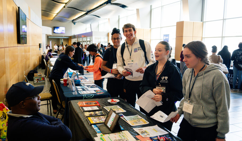 Students walking through the stands at the ninth edition of the Youth Action Conference