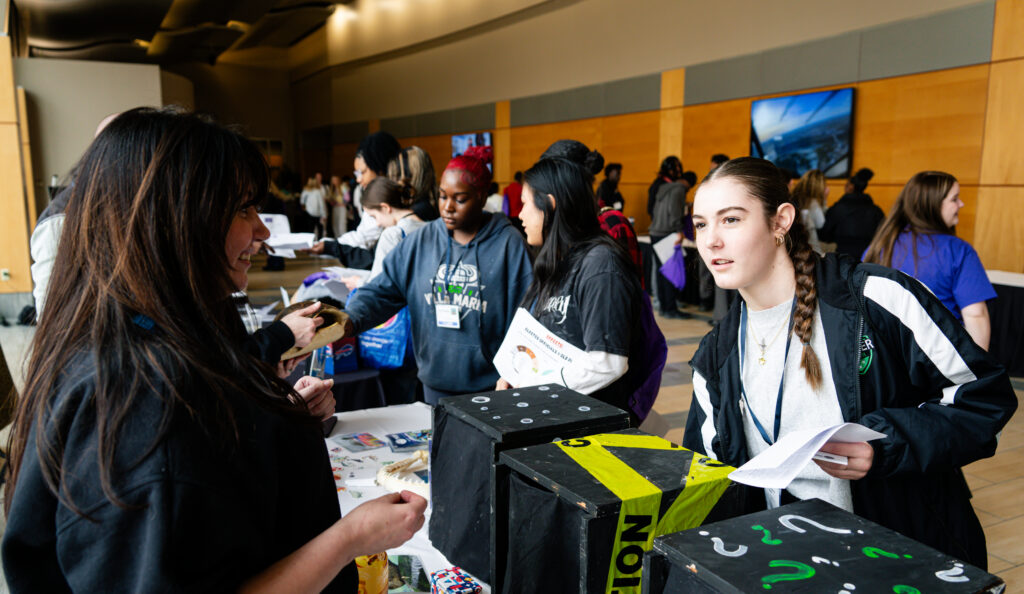 Students walking through the stands at the ninth edition of the Youth Action Conference
