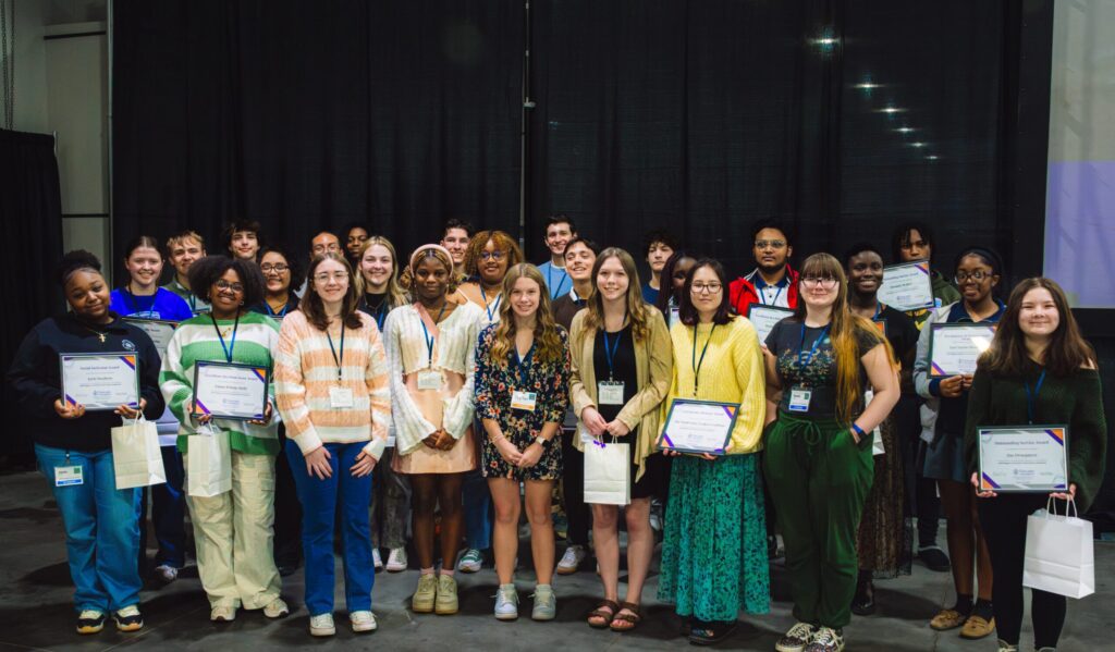 2025 Youth Action Conference students holding their diplomas